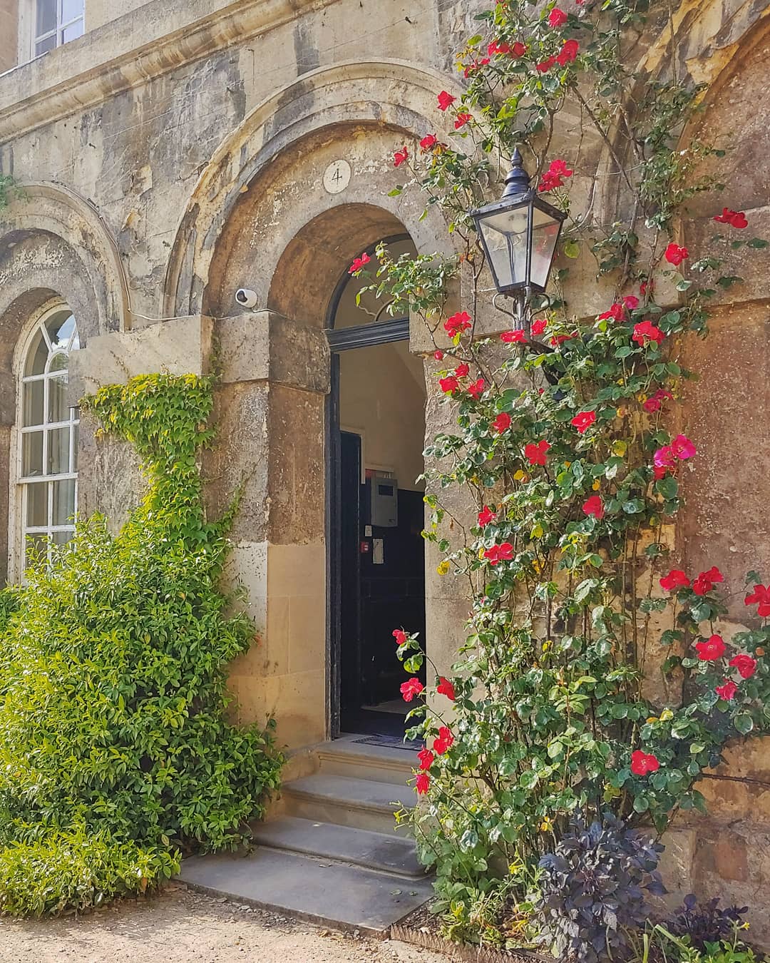 Stone doorway surrounded by red roses, at Worcester College Oxford.