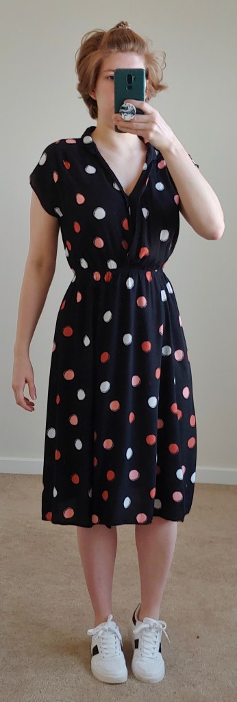 Full-lenth photo of mid-lenth dress with pink, peach and white polka dots.
