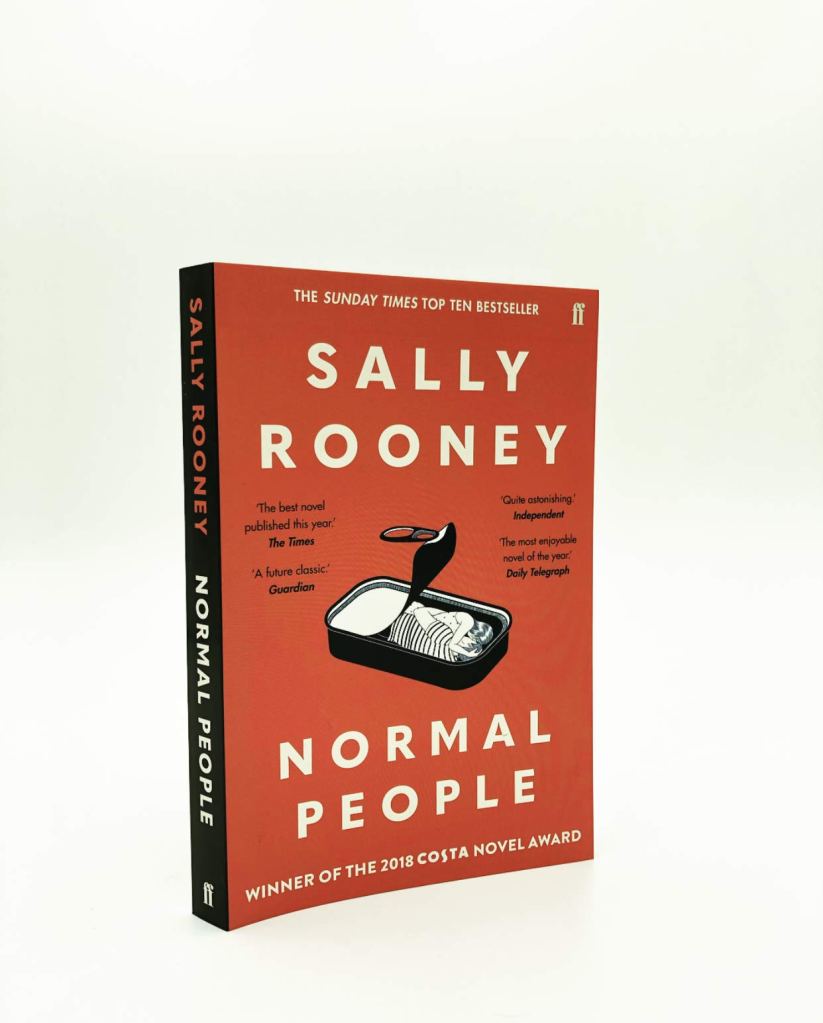 Paperback copy of Normal People, with a black and white drawing of two people curled up in an open sardine tin.