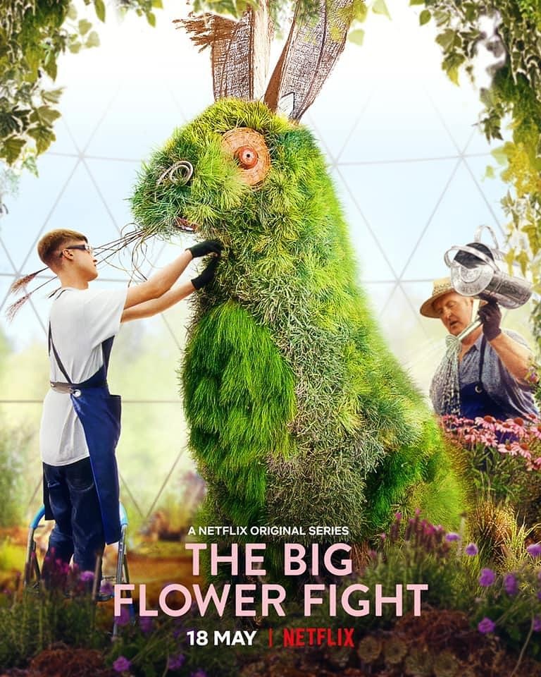 Series poster featuring an older and younger man working on a giant sculpture of a hare made out of grasses.