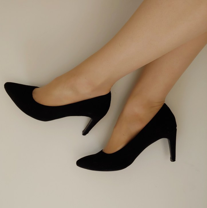Close up of Helen wearing black pointy high-heels with a thin heel.