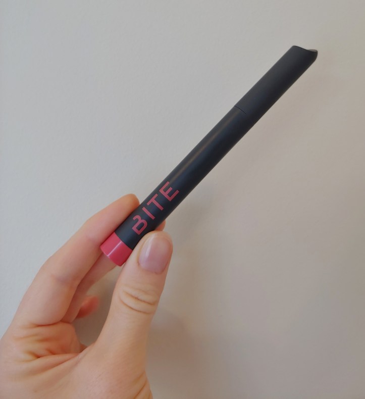 Helen holding the product in her hand, showing it to be a bit shorter than an average pen or pencil in length.