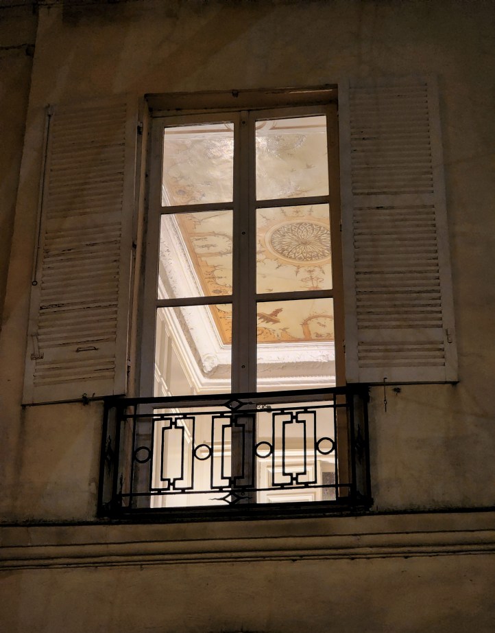 View from a large window with a painted ceiling above.
