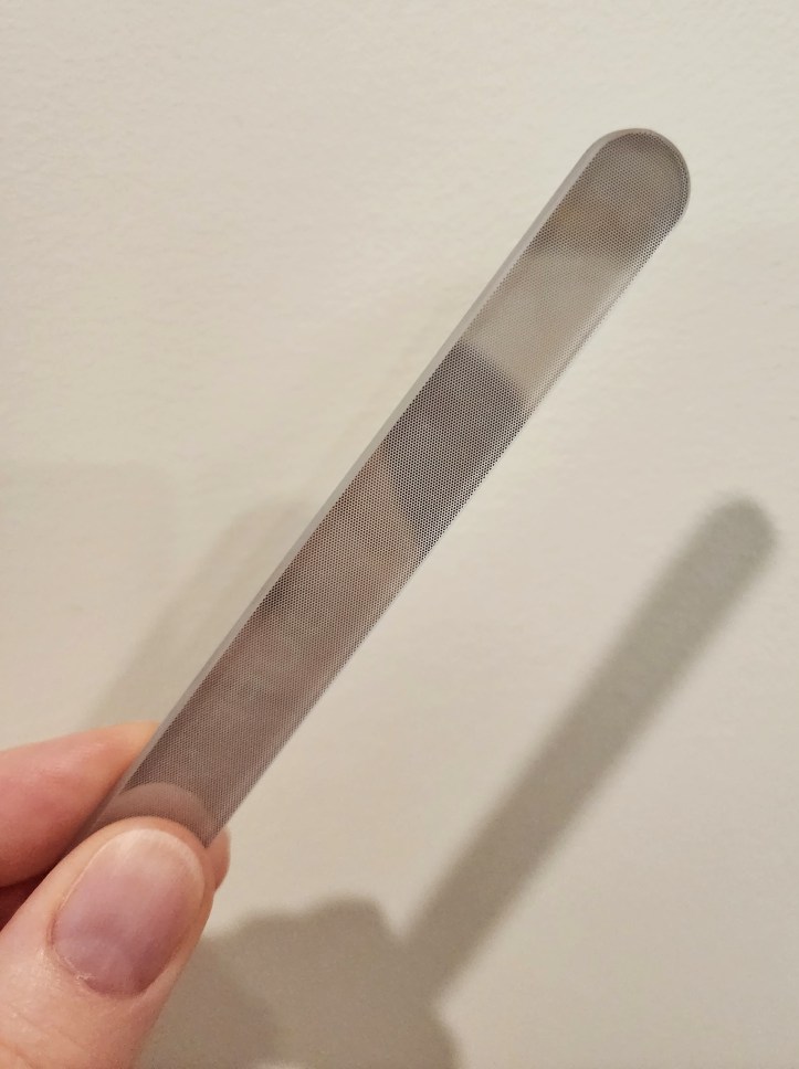 Close-up of the file side, showing a very slightly abrasive surface on a shiny glass background.