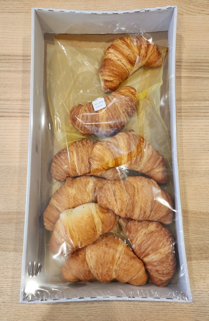 Top down view of a box of bake at home croissants.