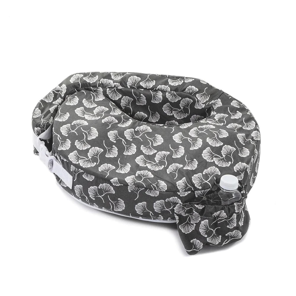 My Brest Friend nursing pillow with a black and white ginko leaf pattern, and a small plastic bottle in the side pocket.